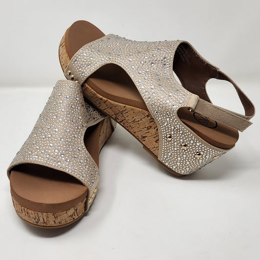 Pair of embellished sandals with cork wedge soles on a white background