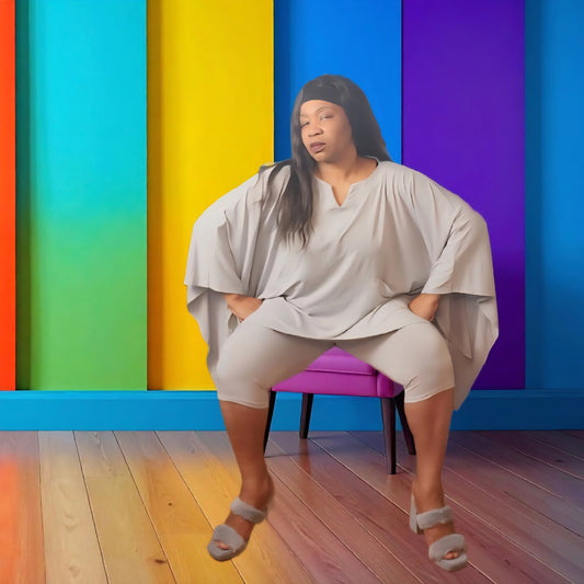 Woman sitting on a chair against a colorful geometric background