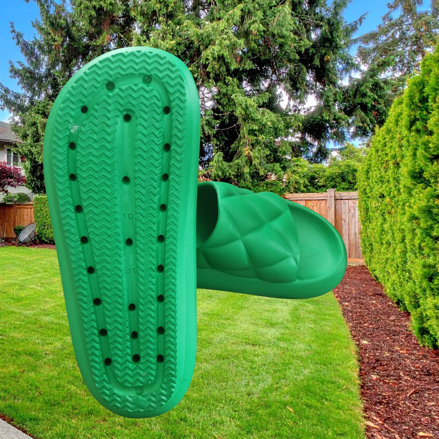 Green garden tool with textured sole on a grassy lawn
