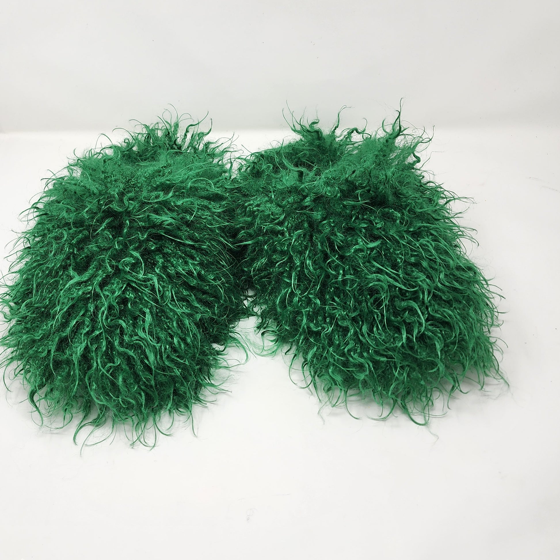 Green fluffy boa on a white background